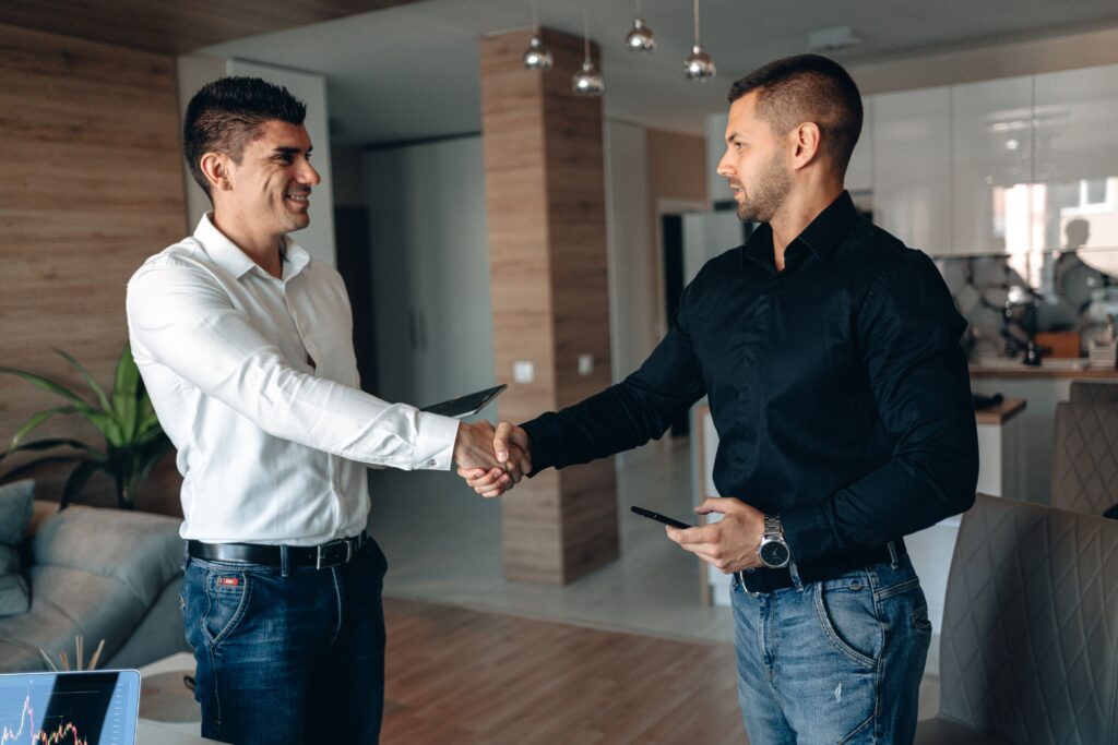 Action Chutes team member shaking hands with a property manager after a completed trash chute installation